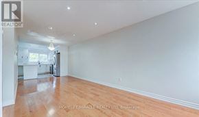 Brampton (Northwood Park) apartment for rent - A spacious room with wooden flooring and white walls.