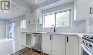 Brampton (Northwood Park) apartment for rent - A kitchen with white cabinets and a window.