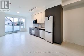 Hamilton (Kirkendall) condo for rent - A modern kitchen with a refrigerator, microwave, and oven.