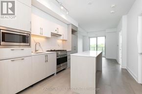 Toronto (Yonge-Eglinton) condo for rent - A modern kitchen with white cabinets and appliances.