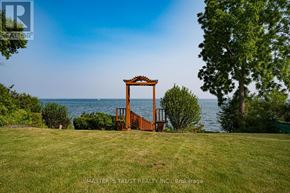 Oakville (Sw Southwest) apartment for rent - A gate stands in a grassy field with a body of water in the background.