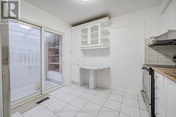 Markham (Milliken Mills West) apartment for rent - A kitchen with white cabinets and a white countertop.