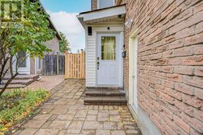 Markham (Milliken Mills West) apartment for rent - A white door is on the right side of a brick wall.