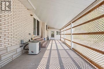 Thorold (Thorold Downtown) apartment for rent - A long hallway with a brick wall and a white ceiling.