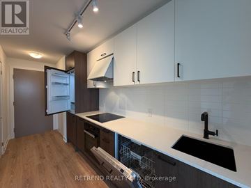 Toronto (Banbury-Don Mills) condo for rent - A kitchen with white cabinets and a black sink.
