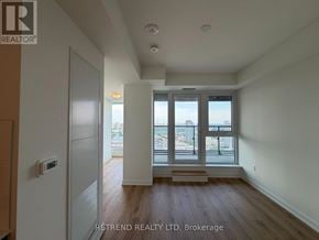 Toronto (Banbury-Don Mills) condo for rent - A room with a large window and a wooden floor.