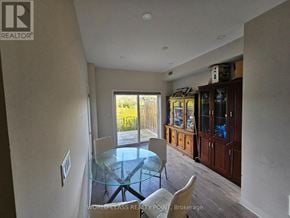 Oshawa (Samac) townhouse for rent - A glass table with two chairs is in a room with a sliding glass door.