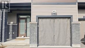Ottawa townhouse for rent - A house with a garage door that is covered in a tarp.