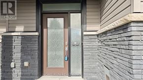 Ottawa townhouse for rent - A glass door with a handle and a keypad lock is the main focus of the image.