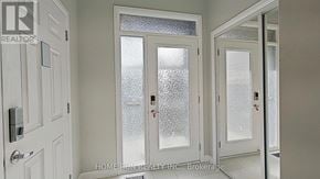 Ottawa townhouse for rent - A white door with frosted glass panels and a keypad lock.