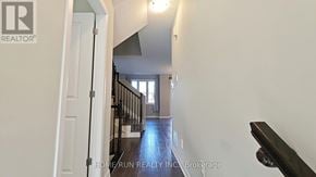 Ottawa townhouse for rent - A hallway with a door on the left and a staircase on the right.