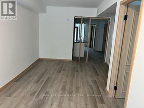 Toronto (L'amoreaux) townhouse for rent - A room with wooden flooring and a doorway leading to another room.