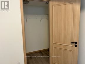 Toronto (L'amoreaux) townhouse for rent - A wooden door with a black handle is closed.