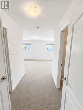 Innisfil (Alcona) townhouse for rent - A hallway with white walls and carpeted floor.