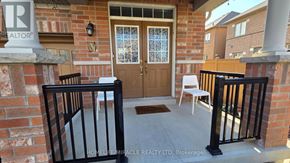 Brampton (Sandringham-Wellington) apartment for rent - A realtor's sign is on a brick wall above a black railing.