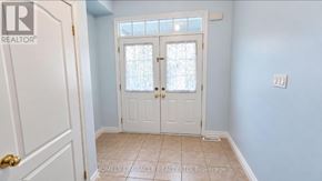 Brampton (Sandringham-Wellington) apartment for rent - A white door with a glass window is in a room with light blue walls.