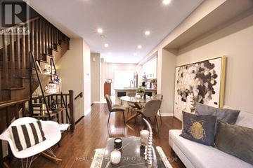 Mississauga (Lakeview) townhouse for rent - A living room with a grey couch and a painting on the wall.