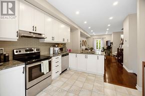 Mississauga (Lakeview) townhouse for rent - A kitchen with white cabinets and a stove top oven.