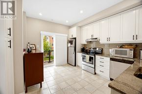 Mississauga (Lakeview) townhouse for rent - A kitchen with white cabinets and appliances.