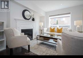 Mississauga (Meadowvale Village) townhouse for rent - A living room with a fireplace and a couch.