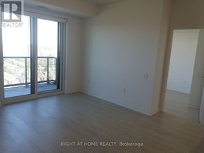 Mississauga (City Centre) condo for rent - A room with a sliding glass door and wooden flooring.