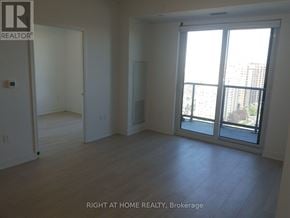 Mississauga (City Centre) condo for rent - A room with a sliding glass door leading to a balcony.