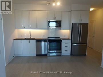 Mississauga (City Centre) condo for rent - A kitchen with white cabinets and stainless steel appliances.