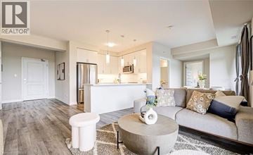 Milton condo for rent - A modern living room with a grey sofa and a white coffee table.
