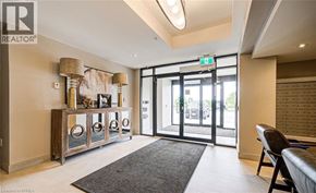 Milton condo for rent - A well-lit room with a grey rug and a wooden cabinet with glass doors.