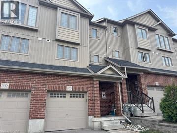 Kitchener townhouse for rent - A two-story residential building with a garage on the ground floor.