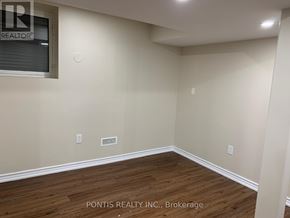 Oakville (Jc Joshua Creek) apartment for rent - A room with wooden flooring and a window showing the word REALTOR.