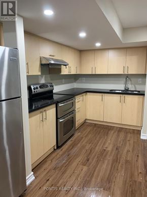 Oakville (Jc Joshua Creek) apartment for rent - A kitchen with wooden floors and a stainless steel refrigerator.
