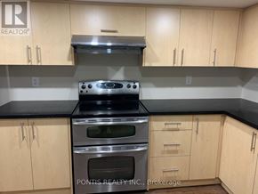 Oakville (Jc Joshua Creek) apartment for rent - A kitchen with wooden cabinets and a stove top oven.