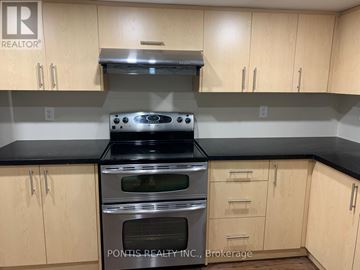 Oakville (Jc Joshua Creek) apartment for rent - A kitchen with wooden cabinets and a stove top oven.