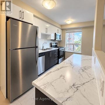 St. Catharines (Downtown) multi-family for rent - A kitchen with a marble counter top and stainless steel appliances.
