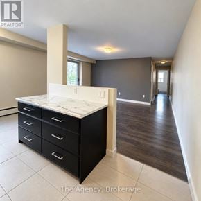 St. Catharines (Downtown) multi-family for rent - A room with a marble top counter and black drawers.