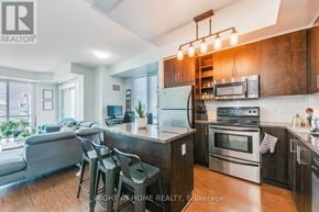 Toronto (Waterfront Communities) condo for rent - A modern kitchen with stainless steel appliances and wooden cabinets.