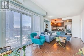 Toronto (Waterfront Communities) condo for rent - A living room with a blue couch and a coffee table.