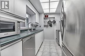 Toronto (Banbury-Don Mills) condo for rent - A modern kitchen with stainless steel appliances and white cabinets.