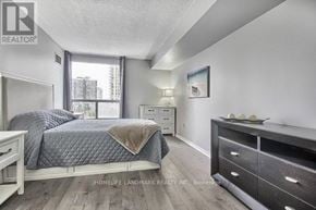 Toronto (Banbury-Don Mills) condo for rent - A bedroom with a bed, nightstand, and dresser.
