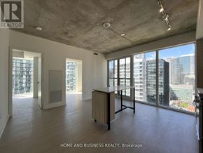 Toronto (Church-Yonge Corridor) condo for rent - A large, empty room with a view of the city skyline.