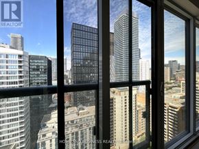 Toronto (Church-Yonge Corridor) condo for rent - A window with a view of a cityscape with buildings of various heights.