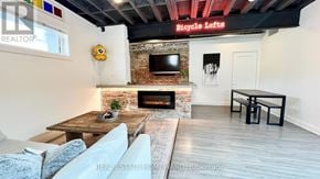 Toronto (South Riverdale) apartment for rent - A living room with a fireplace and a flat screen TV.