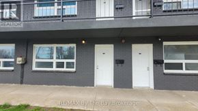 Wasaga Beach multi-family for rent - A building with the words RE/MAX By The Bay Brokerage on the front.