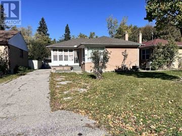 Richmond Hill (Crosby) apartment for rent - A house with a driveway and a tree in front of it.