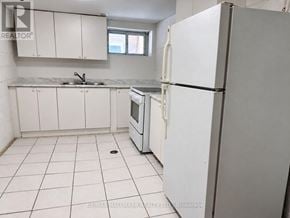 Richmond Hill (Crosby) apartment for rent - A white kitchen with a refrigerator, sink, and oven.