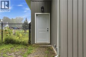 St. Agatha apartment for rent - A white door is closed and locked on a grey building.
