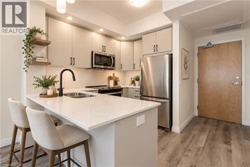 Kitchener condo for rent - A modern kitchen with a white countertop and stainless steel appliances.