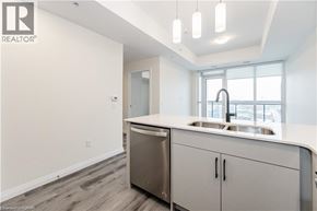 Kitchener condo for rent - A modern kitchen with a sink and cabinets.
