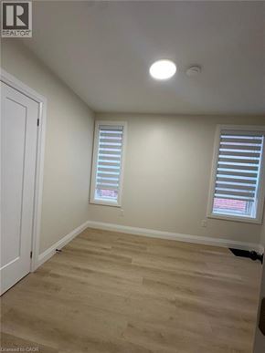 Hamilton apartment for rent - A room with a white door and a window with blinds.
